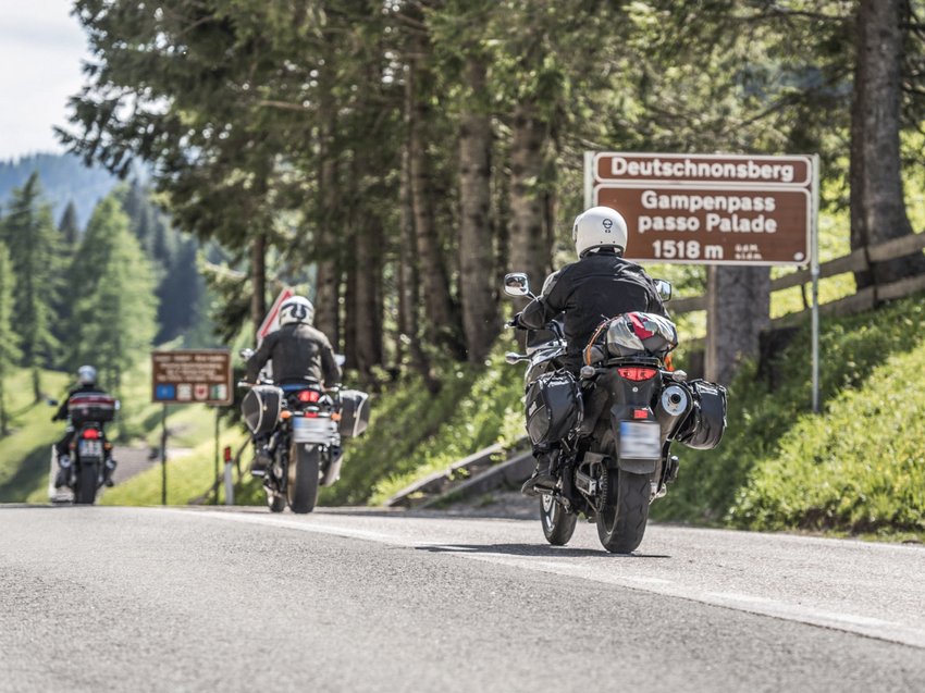 Geheimtipp Hotels in Südtirol 😎☀️ Drei Motorradfahrer fahren am Gampenpass in den Bergen vorbei