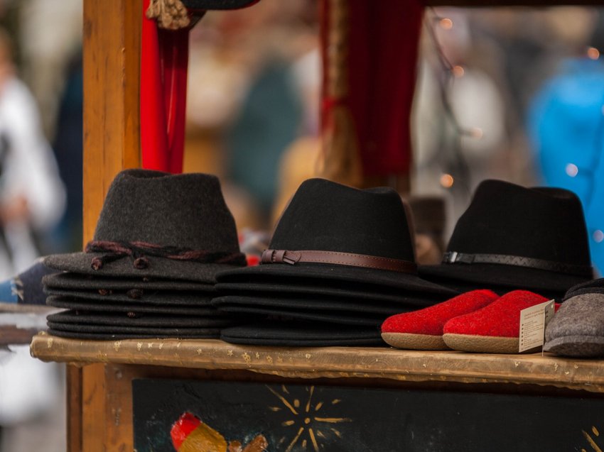 Geheimtipp Hotels in Südtirol 😎☀️ Verschiedene Filzhüte und Hausschuhe auf einem Marktstand